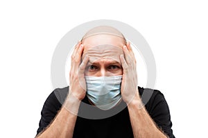 Young adult bald head man wearing respiratory protective medical mask