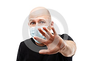 Young adult bald head man wearing respiratory protective medical mask