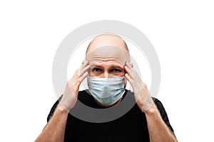 Young adult bald head man wearing respiratory protective medical mask