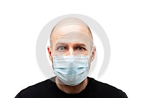 Young adult bald head man wearing respiratory protective medical mask