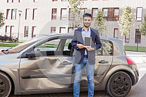 Young adult bearded man insurance inspector looking at camera with smile, holding showing tablet with empty screen for