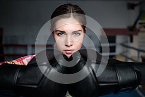 Young adult boxing girl posing with gloves.