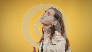 Young adult caucasian woman is feeling anxious on a bright yellow background in studio