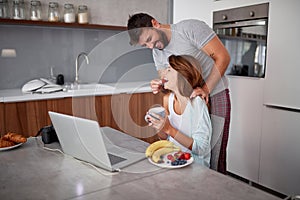 Young adult couple having fun while working. A man feeding with fruit young woman. casual business concept