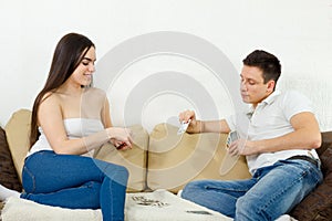 Young adult couple playing cards