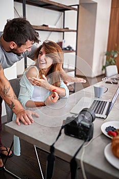 Young adult couple talking and laughing while working. casual business concept