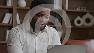 Young adult enterpreneur working happy on a laptop in his office