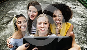 Young adult female friends taking a group selfie