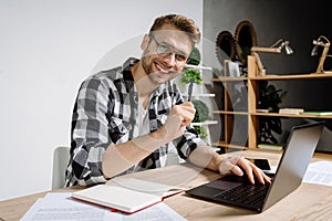 Young adult freelancer working with modern laptop computer