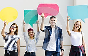 Young adult friends holding up copyspace placard thought bubbles