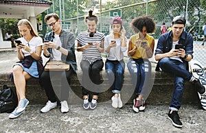 Young adult friends using smartphones together outdoors youth cu