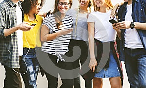 Young adult friends using smartphones together outdoors youth cu