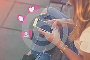 Young Adult Girl Influencer Using Social Media on Smartphone on Outdoor, Like, Follower, Comment Bubble Icons photo