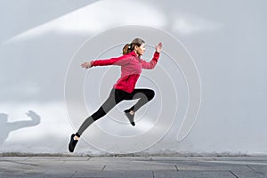 Young adult girl running outdoor in city