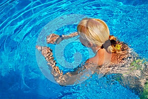 Young Adult Girl Swimming in the Pool