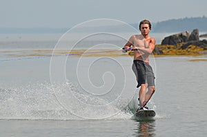 Young Adult Guy Riding a Wakeboard in Maine