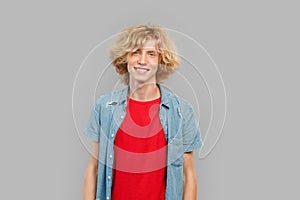 Young adult guy standing on grey background