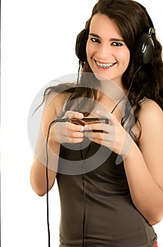 Young adult hispanic girl is listening to the music