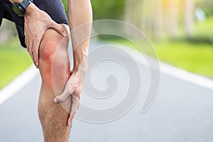 Young adult male with muscle pain during running. runner have knee ache due to Runners Knee or Patellofemoral Pain Syndrome,