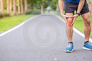 Young adult male with muscle pain during running. runner have knee ache due to Runners Knee or Patellofemoral Pain Syndrome,