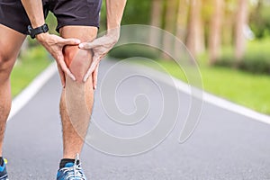 Young adult male with muscle pain during running. runner have knee ache due to Runners Knee or Patellofemoral Pain Syndrome,