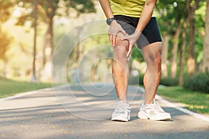 Young adult male with muscle pain during running. runner have knee ache due to Runners Knee or Patellofemoral Pain Syndrome,