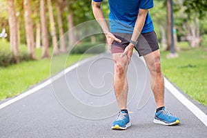 Young adult male with muscle pain during running. runner have leg ache due to Iliotibial Band Syndrome â€“ ITBS. Sports injuries