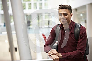 Young adult male student in modern university lobby