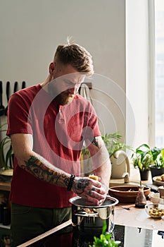 Young Adult Man Cooking Pasta