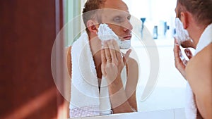 Young adult man foamed face before shaving
