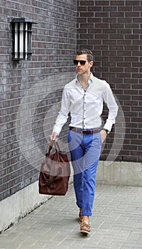 Young Adult Man Holding A Duffle Bag Walking