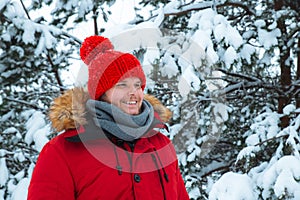 young adult man in red winter coat with red hat with bubo.
