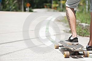 Young adult man with skate board on the road