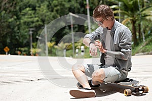 Young adult man with skate board on the road