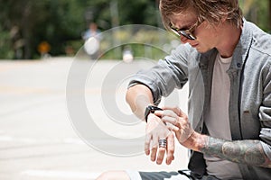 Young adult man with skate board on the road