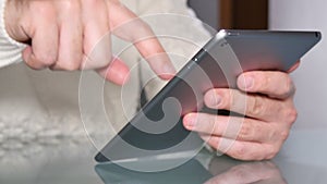 Young Adult Man Surfing Internet with his Tablet