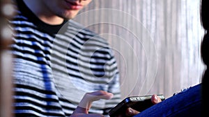 Young adult man using touchscreen phone.