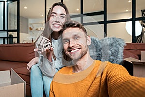 Young adult man and woman move in new accommodation together