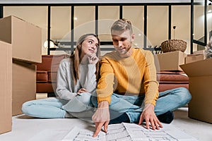 Young adult man and woman move in new accommodation together