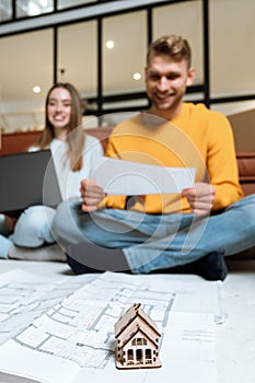 Young adult man and woman move in new house together