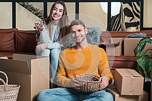 Young adult man and woman move in new rent house together