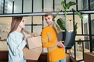 Young adult man and woman move in new rent house together