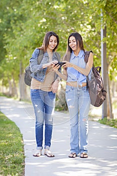 Young Adult Mixed Race Twin Sisters Sharing Cell Phone Experience