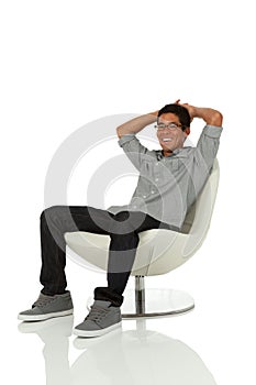 Young adult relaxing on a modern chair