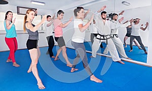 Young adult trainees practicing in karate class