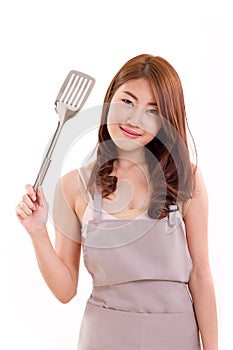 Young adult woman with apron, hand holding spatula