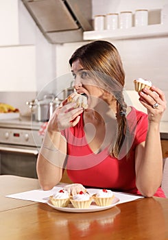 Young adult woman can not resist the temptation to eat a cake