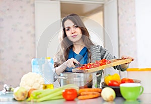 Young adult woman cooking veggie lunch