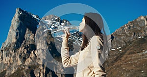 Young adult woman drink water on mountain travel