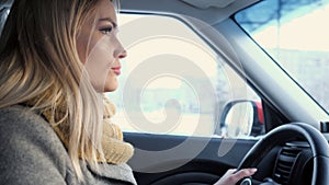 Young adult woman driving car on highway during day time